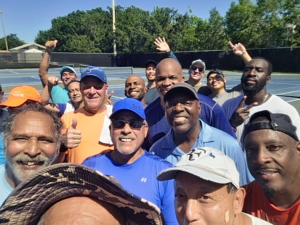Tennis players celebrating on the court.