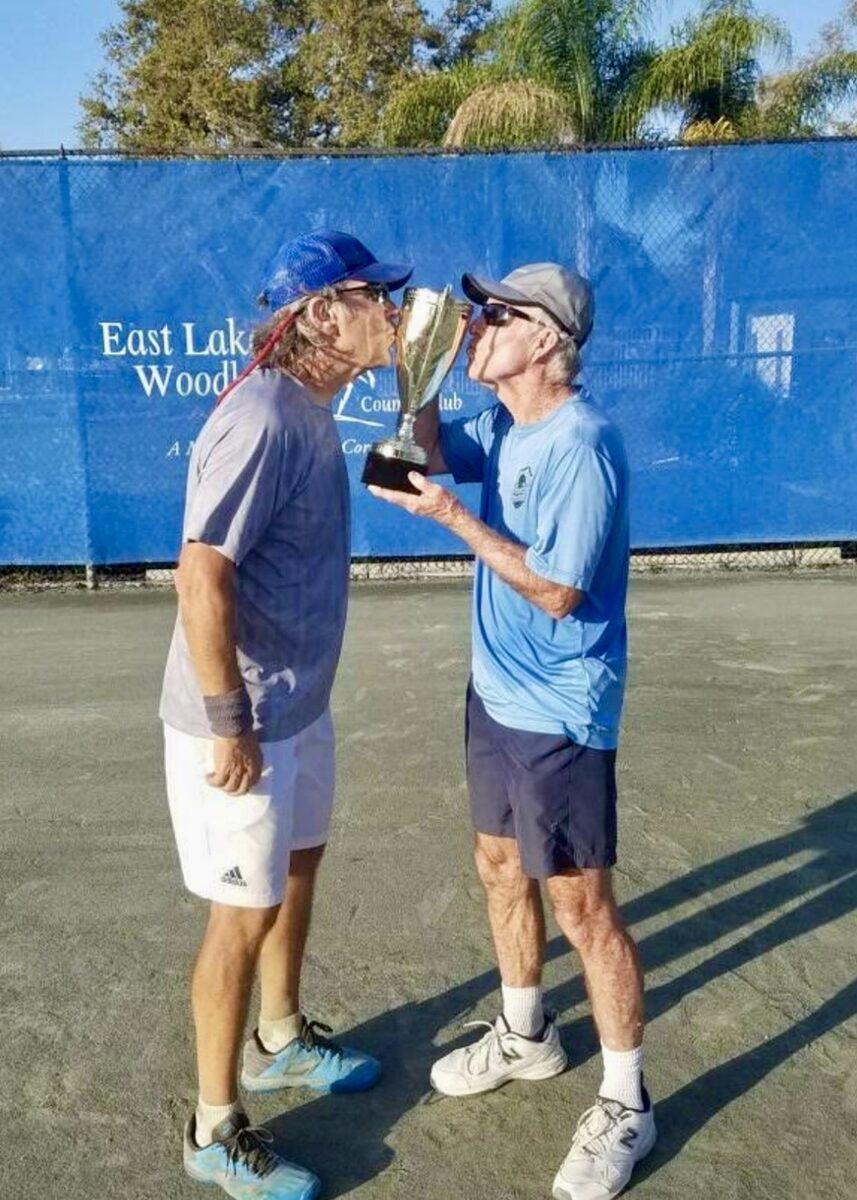 A local tennis player posing with a trophy.