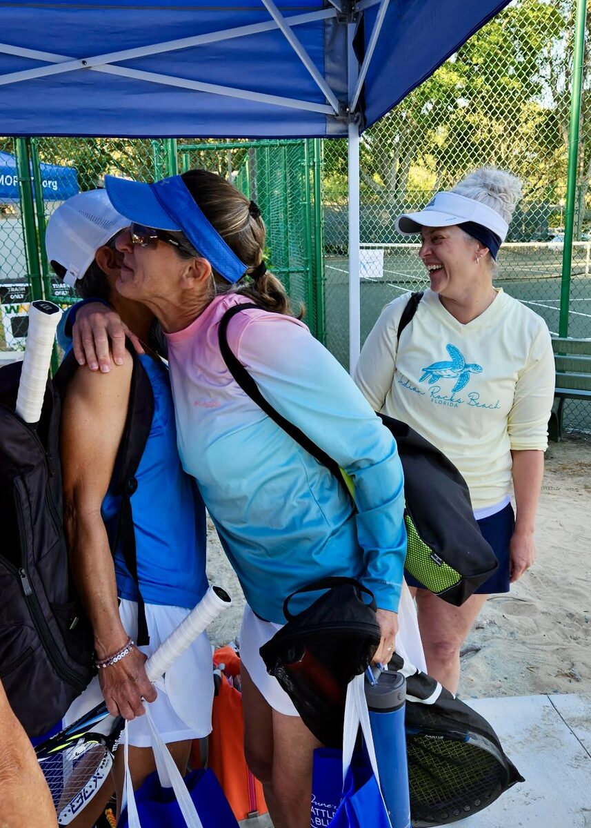 Players sharing a laugh under the tent between matches.