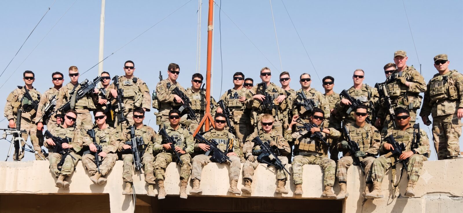 A group of service members together in uniform.